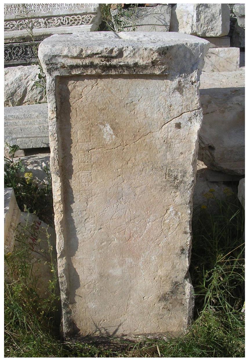 Fic. 6. Alea board from the Hadrianic Nymphaeum at Sagalassos (Sagalassos Project).  of one of the long sides was most probably cut to drain (rain) water from the recessed field which would suggest that the board was intended to be placed in the open air. Lavan considers its findspot, in the centre of the square, a prominent location befitting such a public game board.” The Maltese cross again suggests an origin in the 5th or 6th century AD. At some point in time the stone was recut as only two of the rows are now preserved, an aspect to which we will return below. 