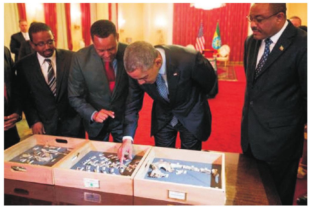 FIG. 4. At the National Palace in Addis Ababa, Ethiopia, 27 July 2015, former US President Barak Obama examines the bones of Lucy the Australopithecine, and reminds us that we are all ‘part of the same human family’. (Photograph: Jonathan Ernst/Reuters, used with gracious permission.). 
