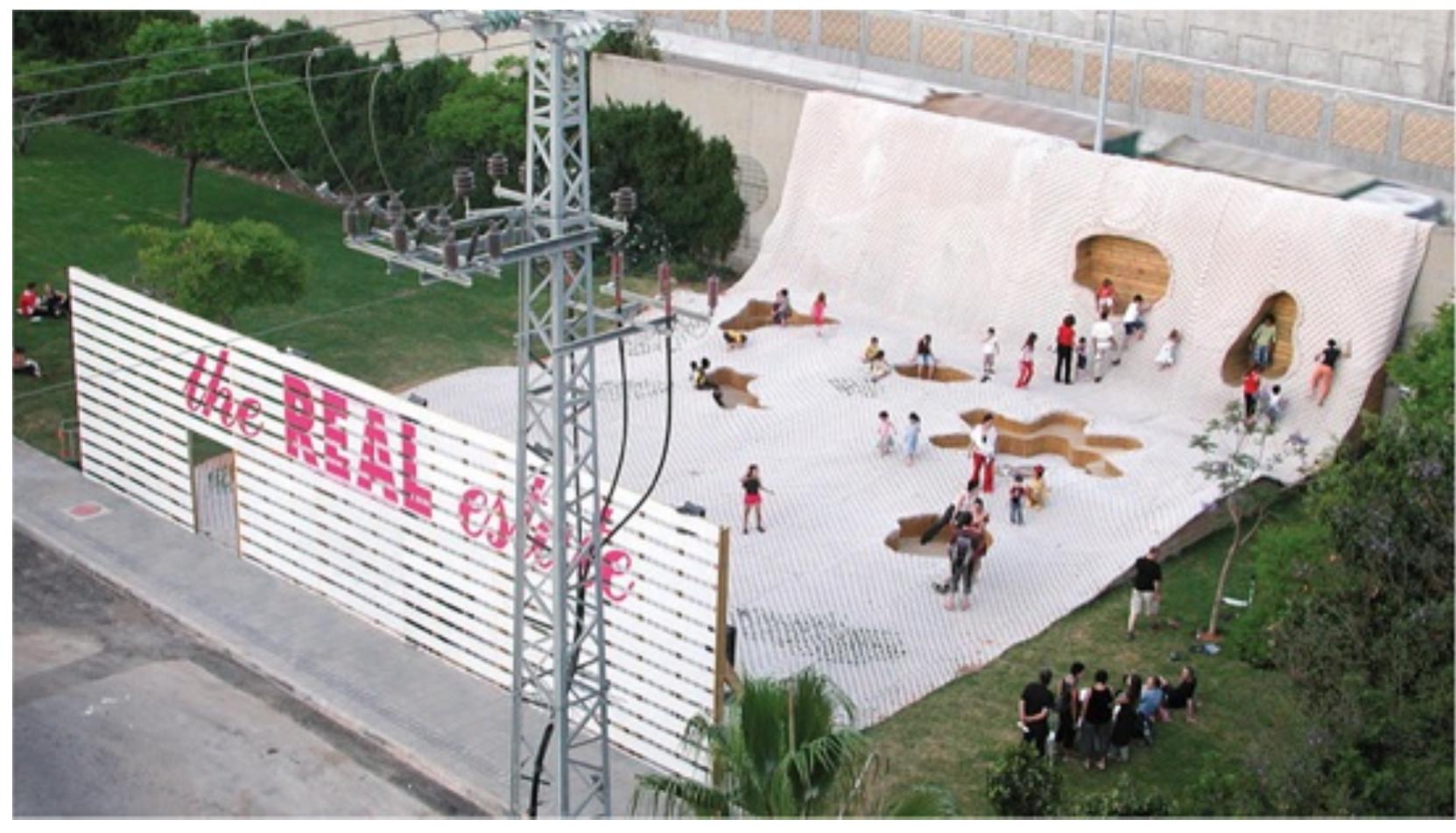 Figure 10.5  The REAL estate, AL/Arch, Bat Yam, Israel, 2012. © Avi Laiser  the promotion of dynamic flows of activity across it (Wall, 1999). The motivation behind this approach is to increase social capacity. Rather than dictating use, open and extensive urban platforms are created on which unexpected events might occur. Geographers Don Mitchell and Lynne Staeheli phrase it this way: “The ideal form for public space is one that allows for a range of activities and for the appearance of a range of identities, but the way that this is managed is left open or unresolved’ (Mitchell and Staeheli, 2007: 120). The creation of the late- modern version of the urban surface is aided by new technologies; in particular, computer software that allows designers to create non-Euclidean forms and complex curves. Exploiting the form-making ability of this software, projects featuring ground surfaces that fold into walls, which in turn become seating and ceilings, have become almost a cliché.  At first it might seem that the urban surface model is intrinsically anti-interior, certainly to  the concepts of enclosure and privacy with which it is so often associated. However. more 