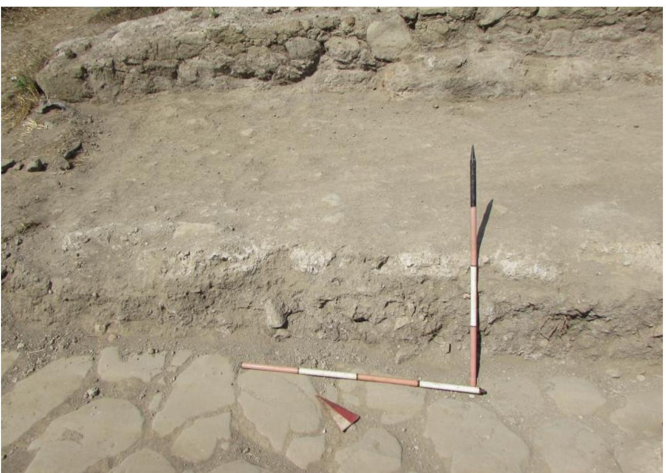 Fig. 17. View of section of late Imperial gravel road surfaces (6059, 6066, 6071, 6072, 6078) covering the Republican basalt pavement (6039) of ROAD 3 in AREA G, with part of tufo block retaining wall (6070) visible (GPR; Author: A. Johnston). 