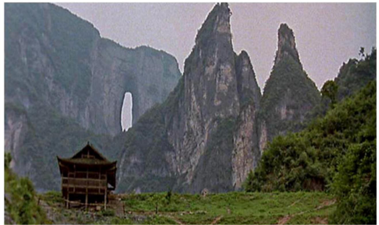 Figure 6. The iconic Tianmen Mountain in Hunan in the background  NOUVEL, FILM AND TRANSLALLIUOUNAL SLORY LELULING 15  f linguistic exoticism for not only Western but also the vast majority of smophone iewers. As previously mentioned, most smophone viewers also have to rely on the ‘hinese subtitles to follow the dialogues in the film. Given the seemingly intrinsic re- tionship between the ‘local’ experience and the ‘local’ language and thereby an nhanced impression of authenticity, it is almost tempting to see the film as the ‘orig- ial’ rather than the ‘adaptation’ of the novel, and the novel in French as the ranslation’ of the film. Note, however, I put ‘local’ in inverted commas, essentially ecause the film was not actually shot in Sichuan but in Hunan Province, which has s own Hunan dialect. Many Chinese viewers would be able to quickly identify the onic Tianmen Mountain (‘celestial gate’) of Zhangjiajie in Hunan — the mountain ith a gigantic hole in the middle — in the background of Luo and Ma’s stilt house ‘igure 6). The breath-taking natural landscape and attraction of Zhangjiajie creates n exotic world for Chinese viewers too. Moreover, the protagonist-narrator Ma,  layed by Liu Ye — one of the best-established contemporary mainland Chinese ctors — converses and narrates in Sichuanese with a heavy north-eastern accent hich could even sound comical to a native Sichuanese speaker.”’ Furthermore, ue to the additional factor of ‘star identification’, the truth about this character — a ative of Sichuan — is considerably undermined by the reality of the actor playing °° What this aural detail highlights is that the paralinguistic elements such as yund and accent, especially in relation or in contrast to the image, are an intrinsic  im  art of the characterization and of the performance of exoticism as well as authenticity. Jaficy remarks that ‘speech and voice have been treated as the guarantors of imme- iacy and presence’” in film studies, and ‘there is a strong tendency in the accented  Ims to preserve the native language as the marker of belonging and authenticity’.”*  