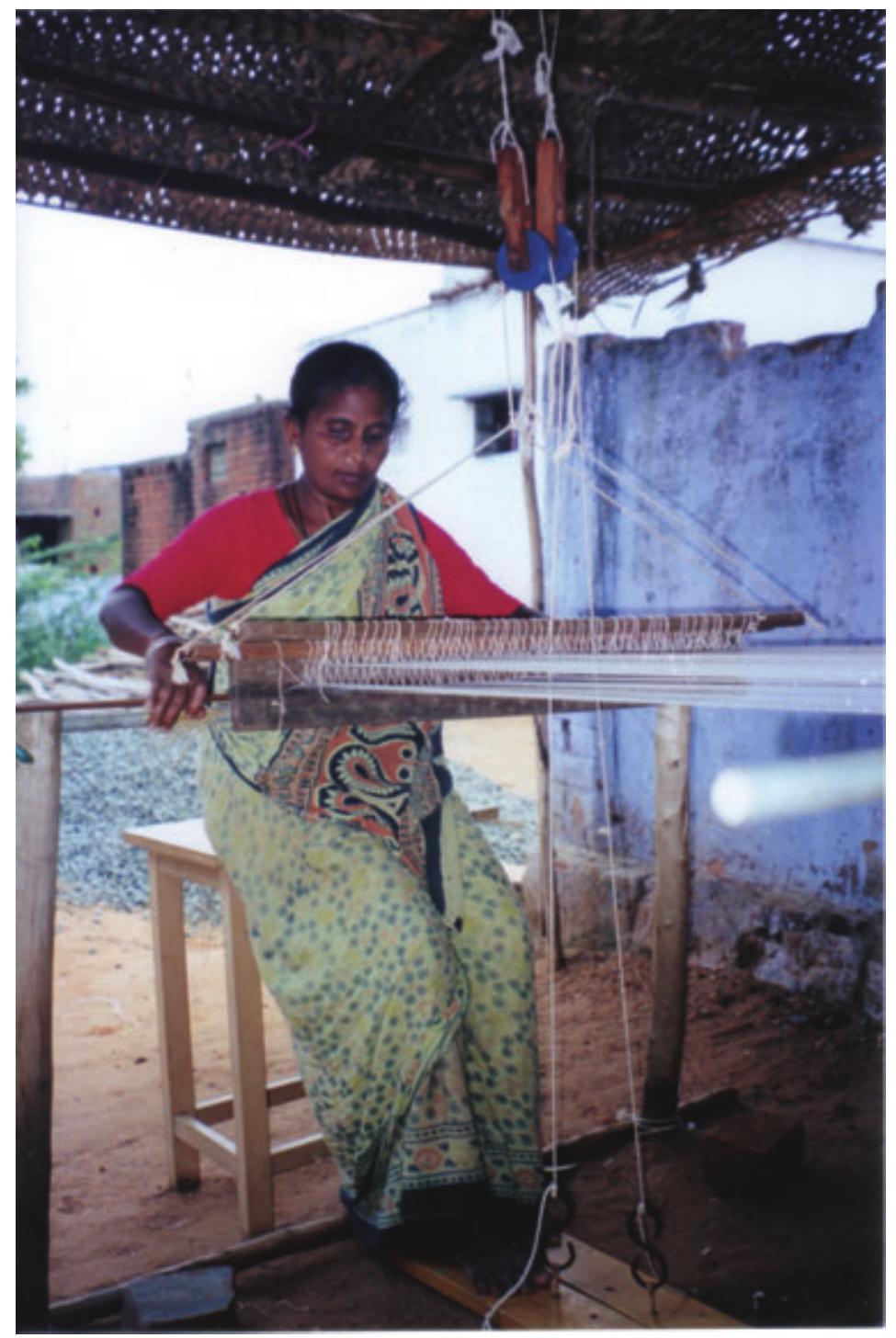 Figure 2. Hassan Fathima sits at the new loom prototype. 