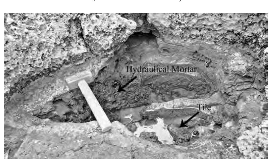 Fig. 27. Cavity in the bedrock on the shore north of the garden wall, with hydraulic mortar (© M. Makki, Geographisches Institut, Humboldt-Universitat). 