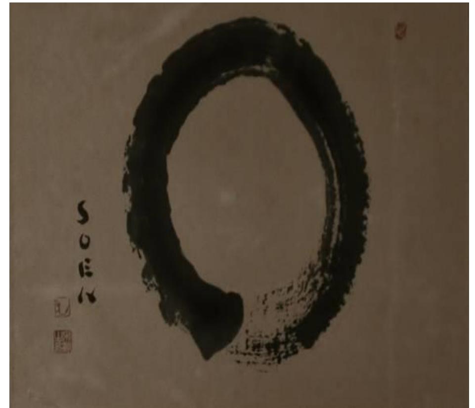 Figure 2: Soen Nakagawa Roshi, Enso, 1907-1984, ink on paper, International Dai Bosatsu Zendo Kongo-ji, Livingston Manor, New York.  The Song Period also saw the beginning of koan collections in Chan Buddhism. These paradoxical sayings were rendered in Chan calligraphy and art.'° This literary culture created a form of living Chan calligraphy known as moji (Japanese: bokuseki), in which the sayings and koans themselves were written in a decorative form.'! One of the most famous forms of moji is the enso, a particularly popular practice in China and Japan (Figure 2).'* An enso is created by a singular brushstroke in the form of a circle. It was supposed to signify enlightenment, power, and the universe itself.'* Ensé embody the living art form of moji, and would translate into other forms of Zen art, such as zenkiga.'*  