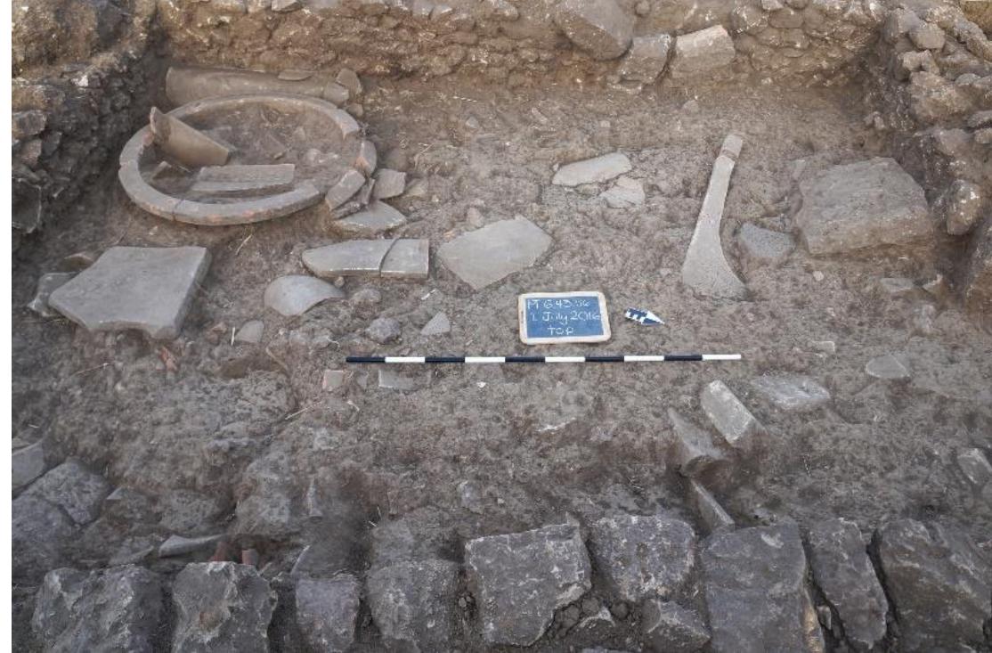 Fig. 30. Room 7 with later Phase 3 resurfacing showing the tops of the basin and bathtub, with the drain in Wall Y visible at far left, looking west. 