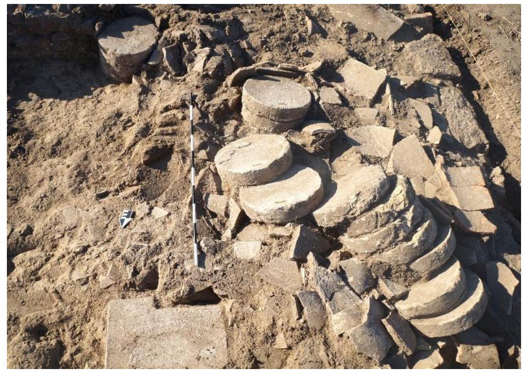 Fig. 38. Collapsed column drums in situ over tile collapse in Room 6c looking south. 