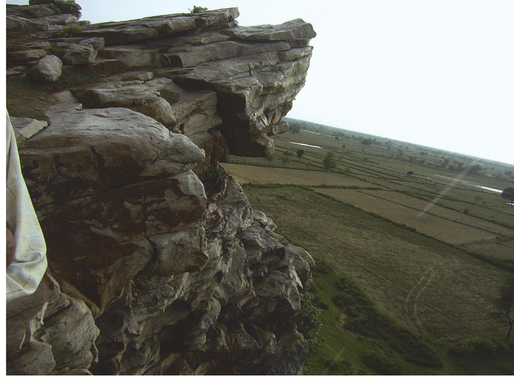 Figure 29: Approach to the caves, Bandrauli  In another painting of the Patsal group (Figure 18), black colour designs are superimposing the obliterated red ones. One arrow symbol in upward direction and the unique motif (possibly related to some religious belief) are identifiable. In another painting (Figure 19) two arrows in black colour are identifiable. The arrow to the left has a snake hanging from it in the lower side. Another painting (Figure 20) depicts a charged up humped bull with upraised tail in red colour. Some circular design possibly representing an animal) is visible above the head of the bull. Another representation of the unique motif of Fatehpur Sikri group is visible in black colour  Figure 21). In another painted scene, an arrow and the unique motif painted in black are visible, these are superimposing earlier painting in red. In another design (Figure 22) a stag is painted in red colour but here the animal is shown with outlines only. 