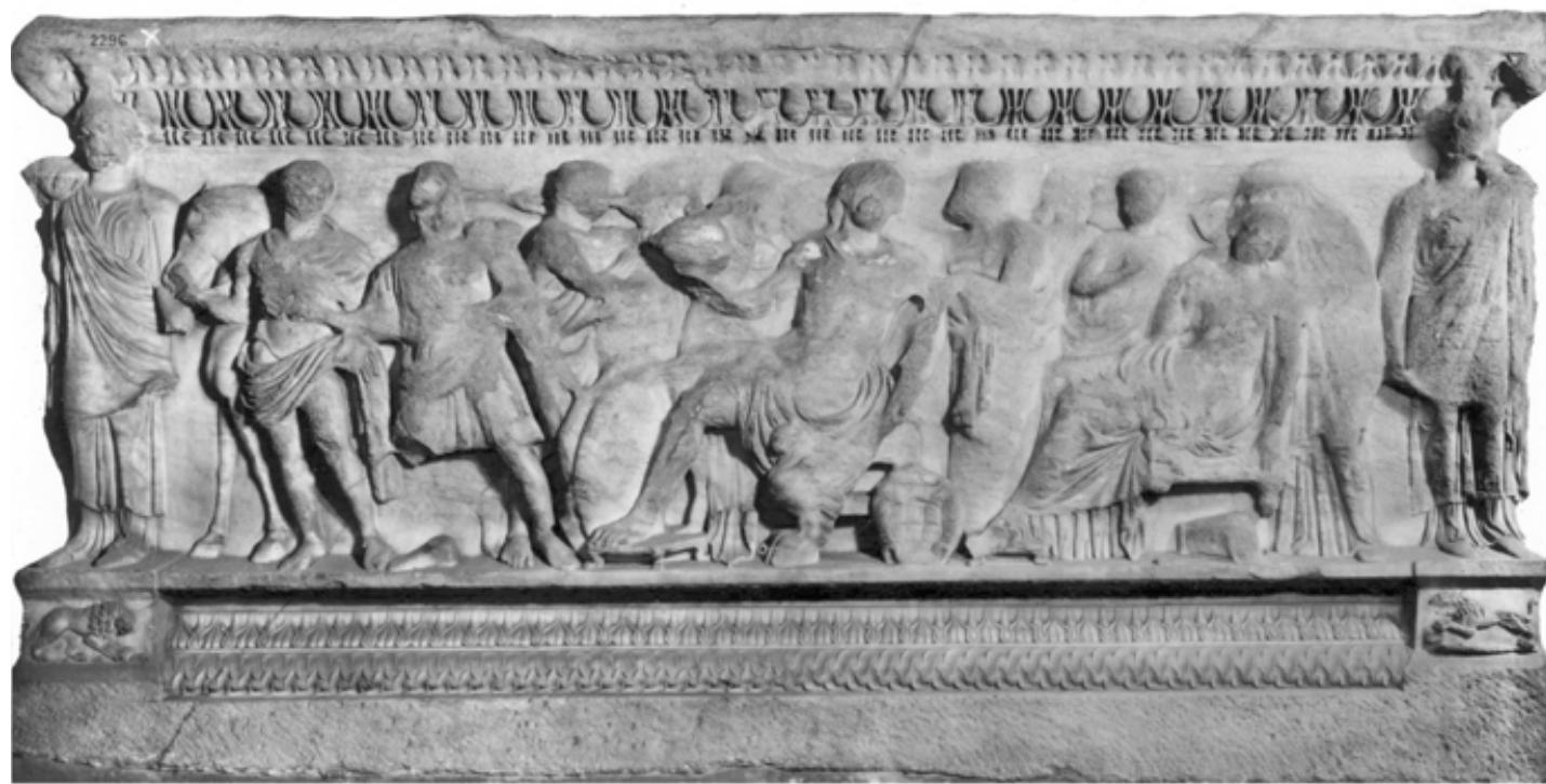 Fig. 8: London, British Museum Inv. GR 1861.2-20.1, 20.3. Attic Achilles sarcophagus. The princi- pal figures depicted on the front side are (from left to right): Diomedes, Odysseus, Achilles (seated, holding a helmet in his right; a lyre leans against his chair), Deidameia (seated, with nurse). The left small side shows Achilles receiving the new weapons from Thetis and Hephaestus, the right small side shows Achilles and Chiron. From from a tomb in Hierapytna (Crete), located between the- atre and amphitheatre, where it was found together with a garland sarcophagus. Late 2nd cent. AD (Photo ©Trustees of the British Museum). 
