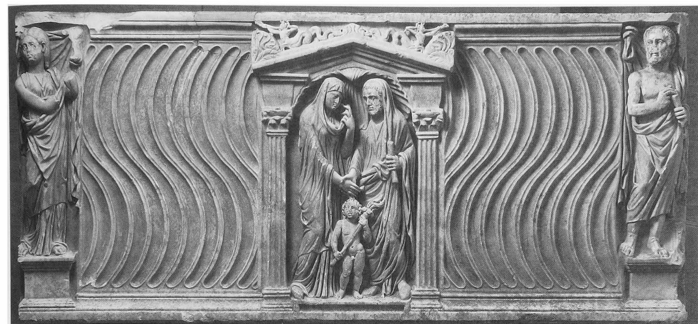 Fig. 2. The juxtaposition of a couple in dextrarum iunctio (centre) with a second representation of the wife  as Muse (left) and a philosopher (right) visualizes an ideal of marriage that is based on philosophical  counseling and moral conduct. Strigillated sarcophagus in Munich, Staatliche Antikensammlungen und Glyptothek, Inv. 533, c.A.D. 220. 
