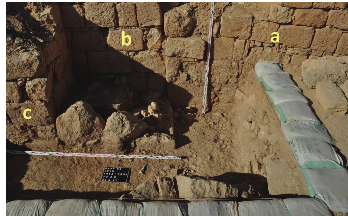 Fig. 5. Buttress — added to the “western segment” from the south-west (photo by P Nocun)  semblage from the upper levels of excavations, including many painted and glazed  ‘The first trench was opened next to the south-western corner within the building. In this area three building elements were recognized: a) a main segment of the structure, b) a “western segment” added to it from the west, c) a buttress added to the “western segment” from the south-west (Fig. 5). The excavations were conducted with parallel observations of the standing walls. Special attention was paid to the shapes and sizes of the masonry as well as the presence of wedges and toolmarks. The stratigraphy of the trench revealed — among others aspects — layers of destruction with numerous  pottery fragments, a layer from the time of reconstruction of the building, and layers  related to the usage of the building in its earlier phases. 