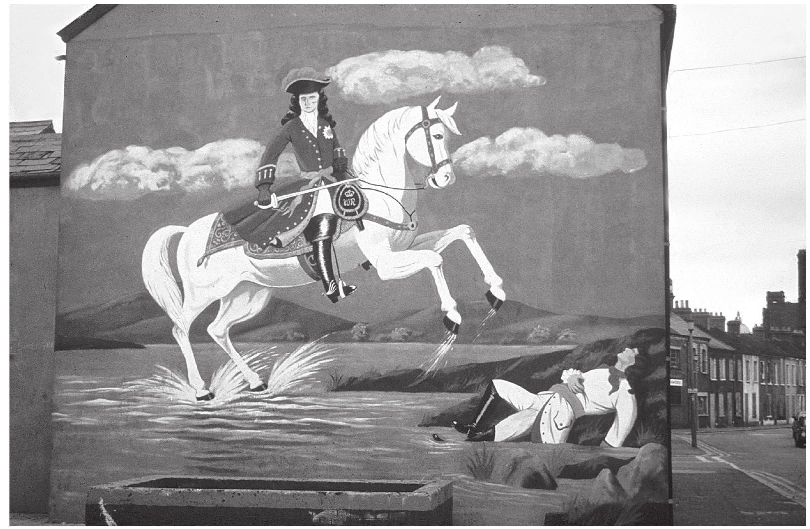 Fig. 4.1: Mural of William of Orange crossing the River Boyne in 1692, Lindsay Street, Belfast 1984 (Rolston 1991: opp. p. 32). Courtesy of Bill Rolston.  and already antique settings - of inherited bardic creations (Sherratt 1990: 817-21).  Both of these modes arguably have fairly widespread correlates in the archaeological record, but it is perhaps above all in imagery, and especially representational art, that this sort of contrast between individual or group ‘statement’ grounded in the present and ‘possession’ of a shared inherited past can most easily be detected. Before turning to imagery in the Greek archaeological record, let me try to illustrate what I mean with some examples drawn from a study by Bill Rolston (1991) of the changing political role of street murals in Loyalist areas of Belfast during the course of the twentieth century. A favourite theme of the street murals to be found in Loyalist areas, particularly from the establishment of partition in 1922 onwards, was a stylised portrayal of William of Orange (King Billy) on a white horse crossing the Boyne in 1690 (Rolston 1991: 20-29): an icon of the far distant past and a symbol of enormous historical significance to the Loyalist community as a whole (Fig. 4.1). If one were to look closely at some of these images I have no doubt that one could probably find some small detail which was strictly anachronistic, but the overall impression is certainly archaic, firmly set in the late seventeenth century. In the period between the 1920s and the end of  