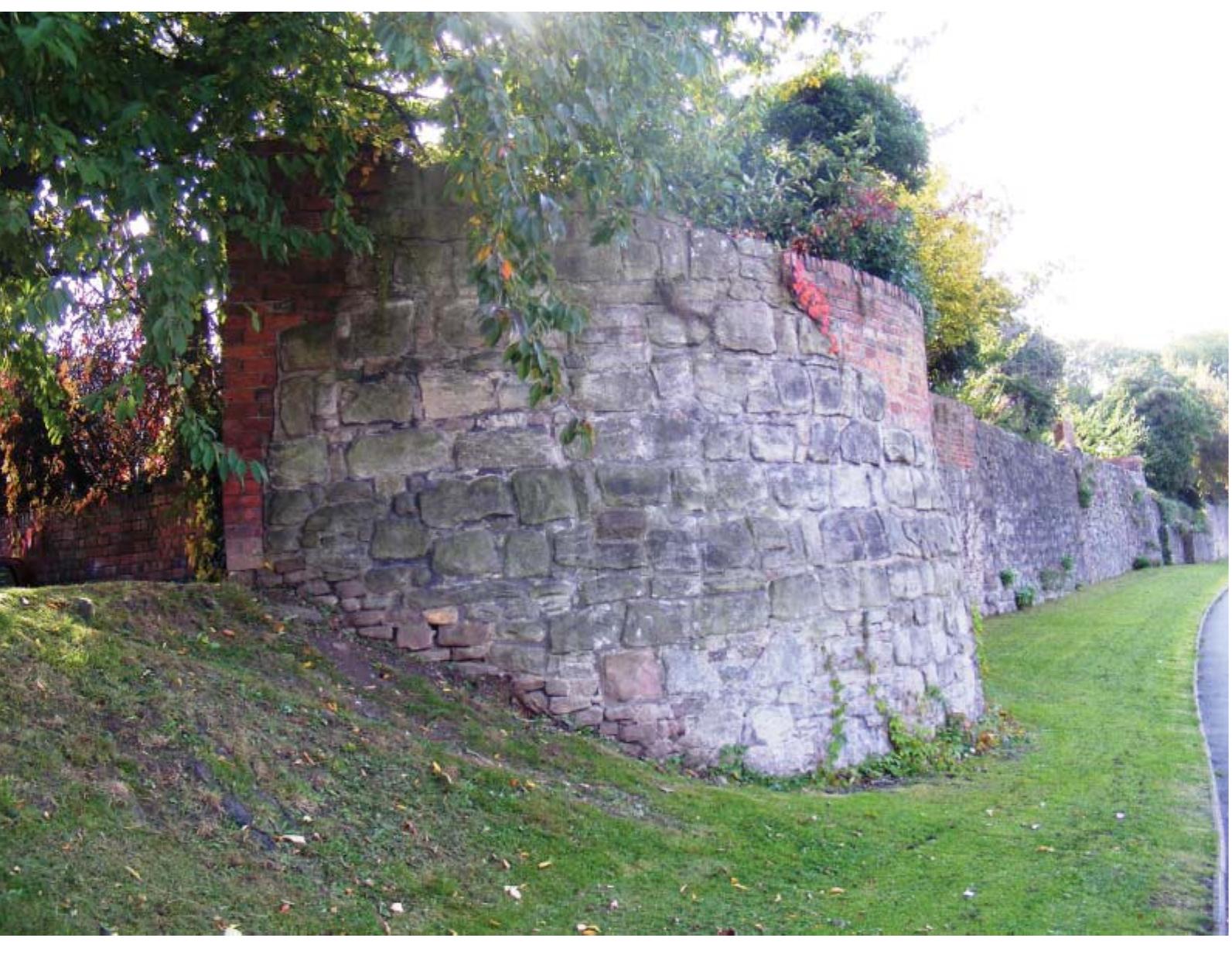 Existing 13th-century city wall. Victoria Street, Hereford. Image © Headland Archaeology (UK) Ltd.  Construction of the ring road in the 1960s, which sought to utilise the corridor of land around the later defences to improve traffic flow around the city, provided the first major opportunity to investigate Hereford’s defences, with the Hereford Excavation Committee founded in 1965 to coordinate the work and obtain funds for excavations. Major excava- tions took place in the west of the city between Victoria Street (1968) and Berrington Street (1972-76), and in the east at Cantilupe Street (1972, 1975). The excavations informed a postulated six-phase defensive sequence produced by Ron Shoesmith.'? This work has provided the basis for subsequent excavations and interpretations of Hereford’s defences. 