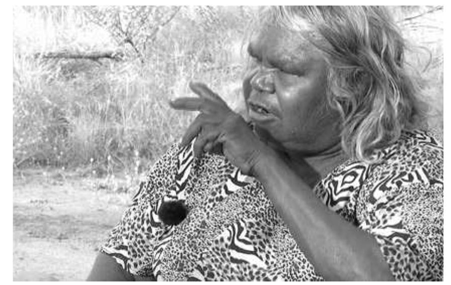 Figure 16: One-handed version of Look sign?®  story about two lovers by saying, ‘Nyakula-pula...’, ‘Those two are looking’. She then directs two LOOK signs, one articulated on each hand, towards each other. The reciprocity of the ‘looking’ action is made explicit by the sign. Where she is describing the man looking at the woman — an action not reciprocated in this instance — the LOOK sign is one-handed and the signer’s gaze is aligned with the direction of the LOOK sign, towards a fictive location in narrative space where the woman may be (Figure 16). 