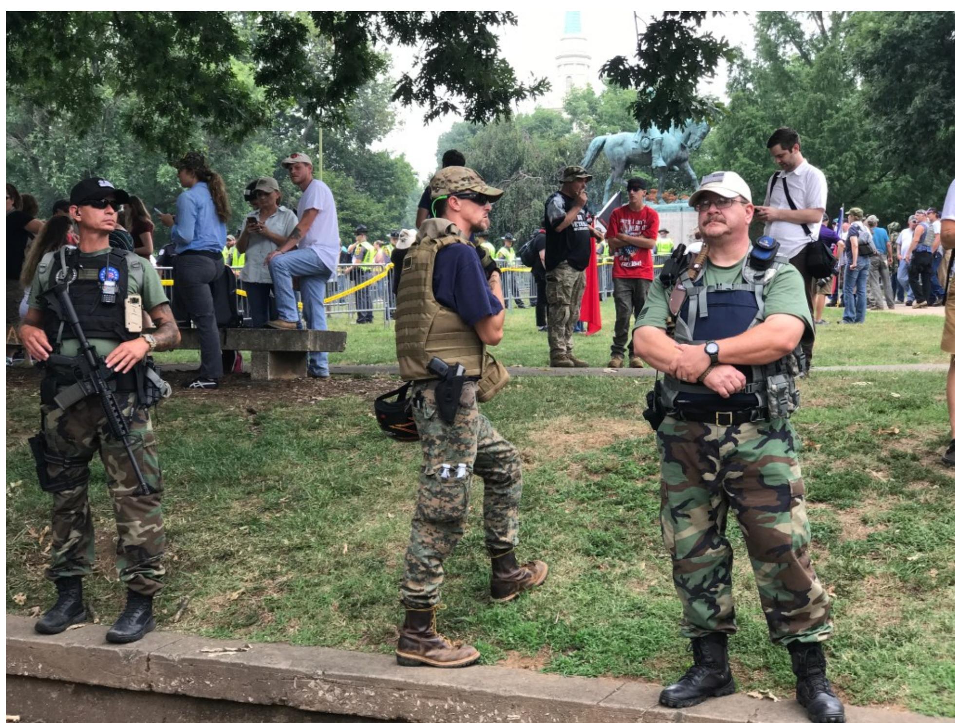 Members of a far-right militia group, The Three Percenters, stand guard in Market Street Park at the 2017 “Unite the Right” rally in Charlottesville, Virginia. Photo credit: Anthony Crider. 