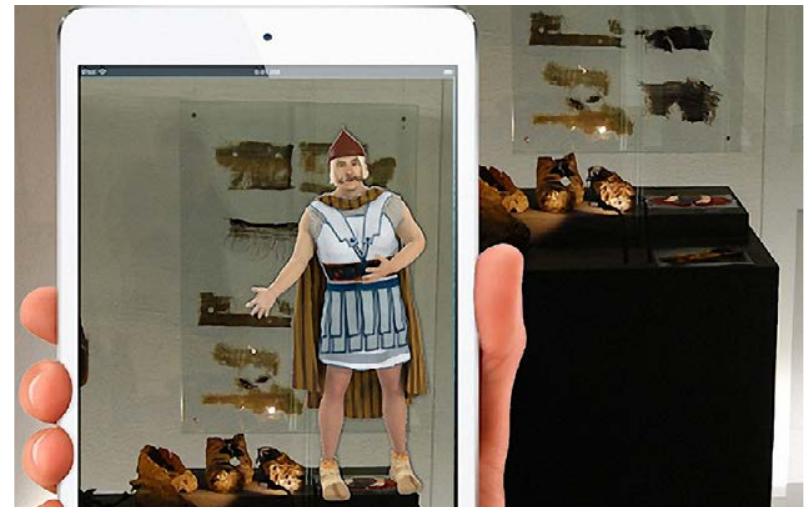 Fig. 5 - The Speaking Celt in the Museum of the Celts (https://heritageinmotion.eu).  learning environment; the first one is spatially bounded audio installations, peepholes, which visitor could lead their ears in order to hear fur- ther information on the exhibition and additionally sensor controlled directional loudspeakers which are active when visitors stand in the designated circles on the floor. The second multimedia is movement based interactive floors which are de- ecting visitors’ selections via pressure sensors on he floor or their movements towards the reflected circles with camera tracking. Their different selec- ion gives them different experiences supported by sound. Kortbek & Grgnbek (2008) explained hat horizontality in this kind of spaces have more Capacity to provide bodily experience since it is in- egrating with visitors’ movements, thus it involves hem with the exhibition while making them com- municate with each other. Lastly, multimedia interi- or suggestion, combining traditional elements with multimedia contents, is consisted of a pressure sensor based staircase, providing bodily scrolling via stepping on different parts of the stairs. Visitors could change the visuals on the screen in front of the stairs via simple steps which stimulate visitors to playful behaviors and interactions.  