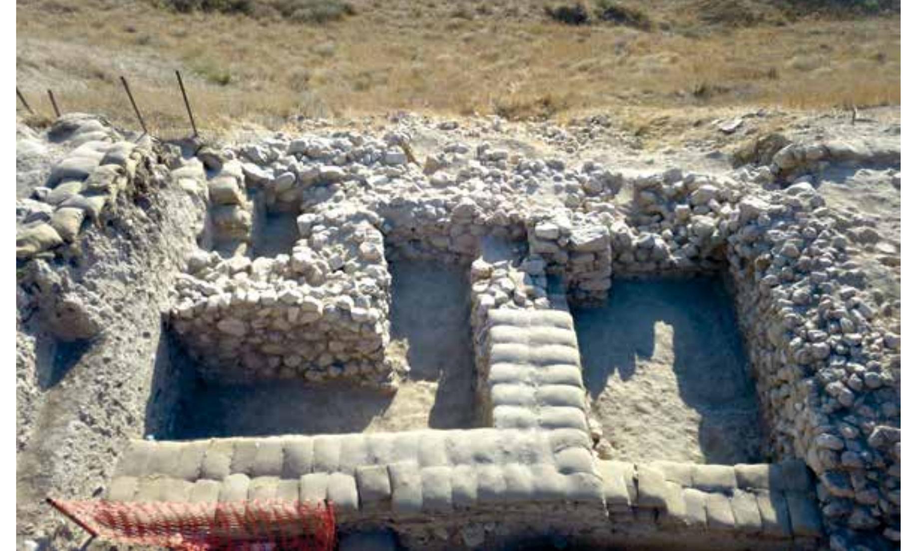 Fig. 49 Early Late Bronze Age fortification in Area S (photo: Jared Dye, © OREA)  Chronology, and (5) anew historical assessment of the period based on the new Chronological trame- work, the results of the study on material culture, and a critical study of the available text sources.  continued  fort (Fig. 48). In Area S, we continued to excavate settlement contexts of Age outside a substantial building (Strata S-3 and S-4) and uncovered a sub  In July/August 2019, the third season of excavations was conducted  at Tel Lachish. Work  in Area S on the western side of the mound and in Area P north of the Judean palace/  the early Late Bronze stantial fortification  of the early Late Bronze Age (Fig. 49). Notable finds include two scarabs from floor surfaces,  a bowl fragment inscribed in Hieratic and a sherd of a Cypriot White Sli early alphabetic inscription (already discovered in 2018). In Area P, we continued  eastern ex  the P-4 pa palace tha  p II milk bowl with an  o excavate the  ent of the Middle Bronze Age palace and cleared two rooms full of destruction debris, uncovering well-preserved white plastered mud-brick walls (Stratum P-4). A sounding beneath  ace floor revealed a hitherto unknown massive earlier phase of the Midd will be further explored in the coming seasons. East of the palace, we  le Bronze Age raced an enig-  matic feature that cuts into the Middle Bronze Age remains and dates to the Iron Age. Currently, we interpret this feature as a massive, at least 2.5m-high (underground?) retaining wall from the hat kept the ruined Middle Bronze Age mud-brick palace in place in order to build the  [ron Age t  