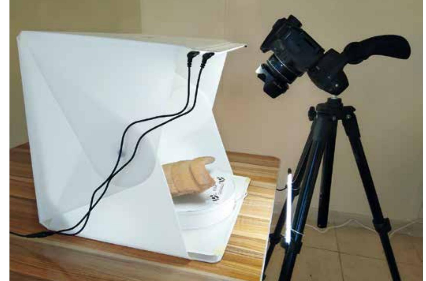 Fig. 70 The use of 3D photogrammetry equipment (photo: M. Bérner/OREA)  For documenting an artefact with this method, the object is positioned on the turntable inside the tent. LED light strips installed on the inner top of the tent allow for an optimal illumination. During the photogrammetric recording process, the turntable stops automatically during a 360° rotation while the object is being photographed. This procedure is possible due to an IR connec- 