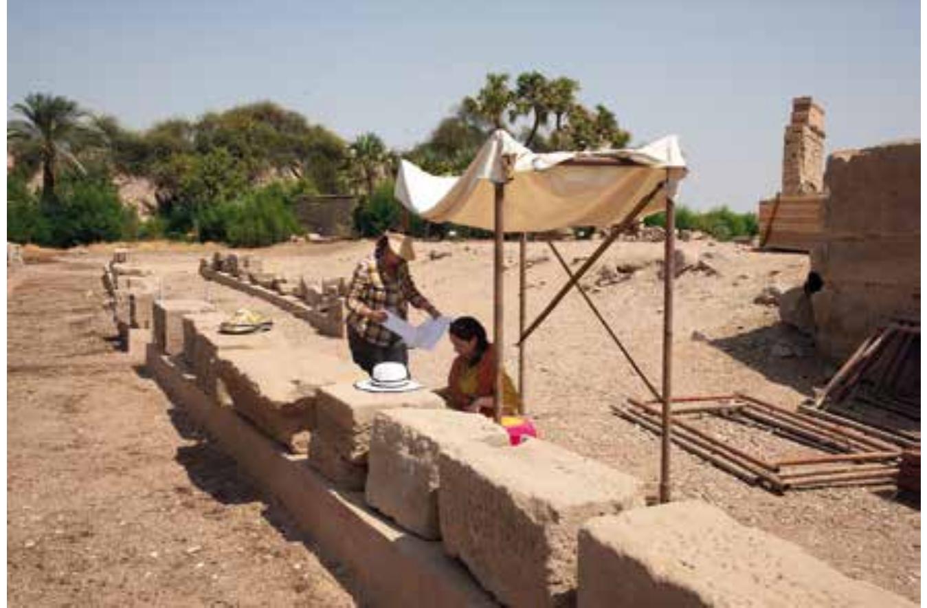 Fig. 78 Silke CaBor-Pfeiffer and Pauline Calassou revising the facsimiles of reliefs on temple blocks from Philae (photo: H. Kockelmann)  ae  With the kind permission of the Ministry of State for Antiquities, Cairo, the team focused its activities on the epigraphic study of the Temple of Hathor. In the autumn field campaign, we checked our copies of the scenes and inscriptions against the original reliefs in preparation of the first full facsimile edition of the Hathor Temple including transliteration, translation and photographic documentation. Members of the mission were Holger Kockelmann (director), Silke Cafor-Pfeiffer (epigraphist) and Pauline Calassou (epigraphist). The work started on 5" October; the last working day in the field was 31* October 2019. In the fieldwork, we concentrated on the  