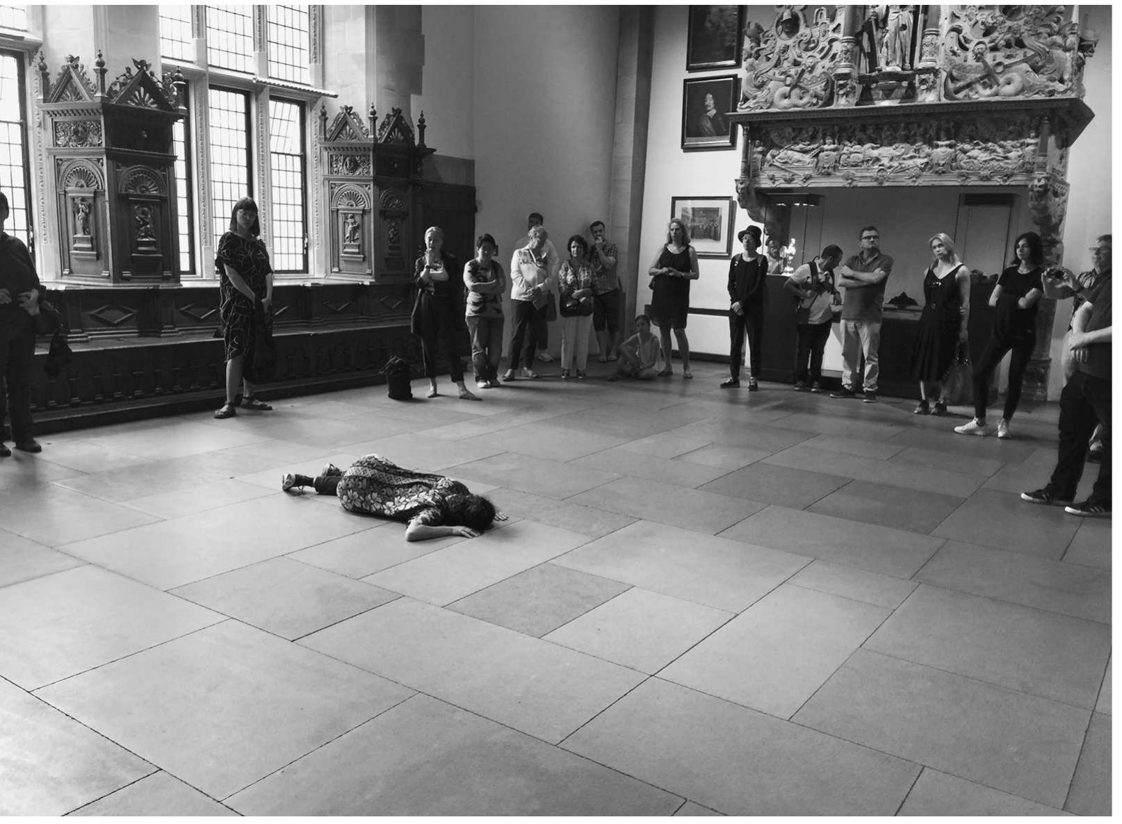 The distancing in Pirici’s work was obvious to anyone in the audience at Minster, but | want to emphasize that it ap- plies to both the traditional objects of commemoration and me. diation. This event might have been seen as part of the turn to scarcity, a performative action to which one had to travel (and stand in line, which, in fact, | did). Photography was permitted and welcomed, however, and Pirici’s work, as is the case with most contemporary performances, was more than visible on In- stagram, Facebook, twitter, and other social media platforms.® Pirici built up a space between performance and audience, and at the same time a connection, inviting corporeal engagement, and participation, which translated into the ability of the audi- ence to frame, choreograph, and make choices for their own stream.  