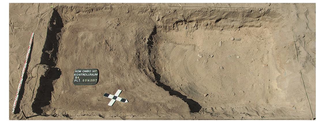 This was a trench of 1.5 x 5 m within the foundation area of the Control Build- ing (figs. 1. 8). Modern pits (s/2-L1 and s/2-L4) have cut into red burned mud brick debris layers (s/2-L2 = s/2-L5 and s/2-L3) which are redeposited material from the First Intermediate Period town. That the ayers are recent was confirmed by modern garbage (plastic bags) just 40 cm from the surface; the pottery was mixed and included fragments of Old Kingdom and First Inter- mediate Period carinated bowls and beer jars as well as Roman amphorae. Sealing mass and a silex blade were also found. At the bottom of the pit (s/2-L1) was yel- ow sand, within which were fragments of modern glass and cigarette filters.   Since the layers testifying to more recent activities continued to a depth greater than the planned Control Building foundations, excavation was halted in Areas s/2 and s/4. 