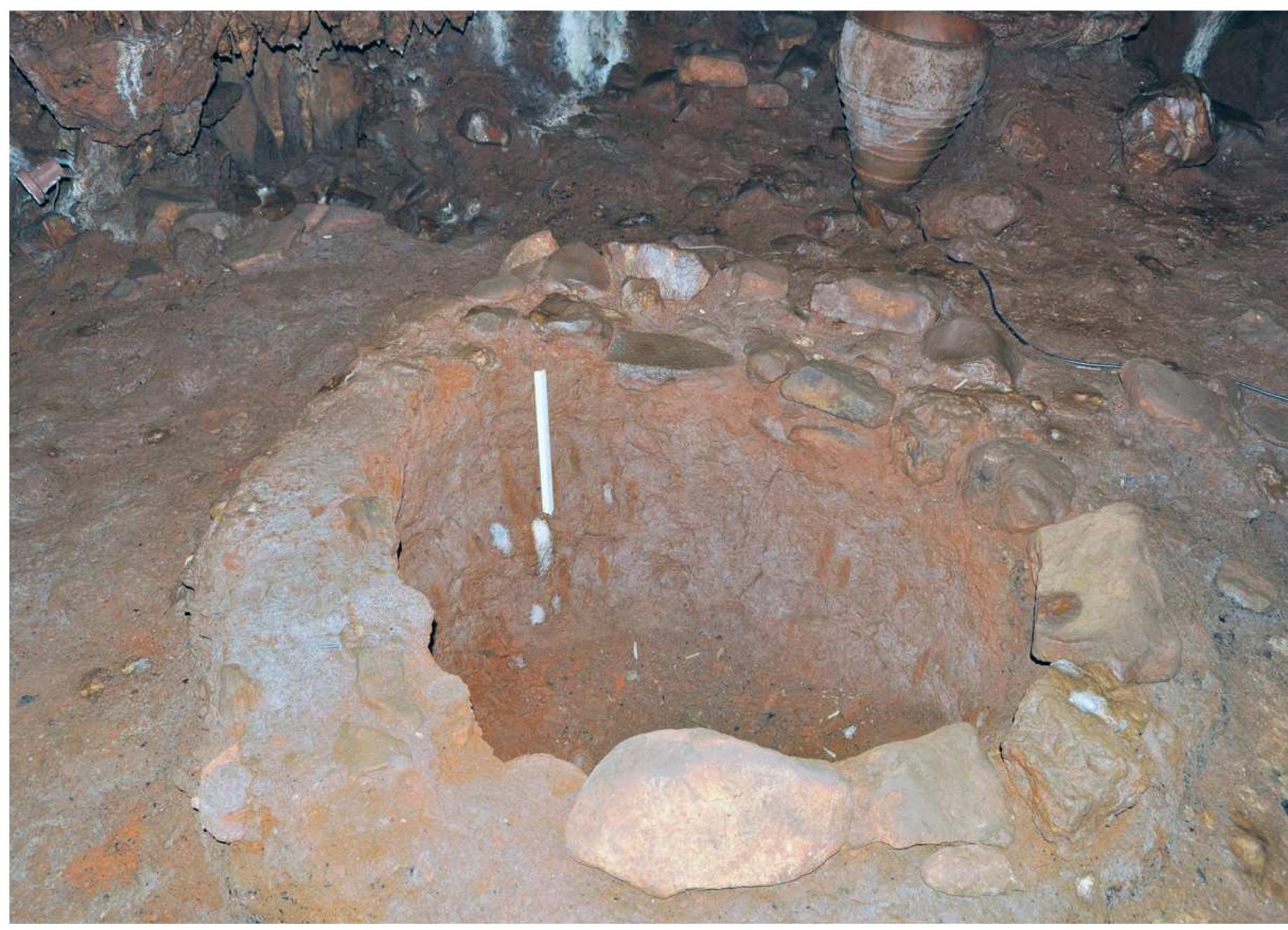Fig. 2. Large deep, wide-mouthed storage pits lined with clay.
 of the same nature as for Alepotrypa, though the presence of burials seems to indicate a place
for worship and negotiating ancestral rights, amongst other reasons, for its ‘raison détre’.®
 PUT WEST GH Pe YULIGUIIIY GILES GL PIQIIts, GITIUIIYSt ULIIe PeGSUils, PUT MS PUPOUIE Ue

Prior research had claimed that domestic activities and specialised crafts were conducted
inside the cave, such as weaving,® sewing, basketry and tool manufacture (Papathanasopoulos
1996, 83), whereas outside of the cave were claimed to be the potters. Inside were large, deep,
wide-mouthed storage pits lined with clay and encircled by stones (Fig. 2). However, from the
middle of the LN and throughout the FN there seems to have been an economic and social elite
(Papathanassopoulos 1996, 84) which denotes its presence through the objects of prestige, such
as jewellery of silver, bracelets of Soondylus gaederopus shells and, non-utilitarian painted pottery.

No matter what the habitation pattern of the cave, those that were ultimately buried there
seem to have been subsisting mainly on C, plants with little evidence for marine food included
in the diet, according to the stable isotope study (Papathanasiou 2003). The usage of inland

citac ac tha narmanant hoahitatinn nlarac af thhnca that 1icad tha cava may nartly iictifiy thic
