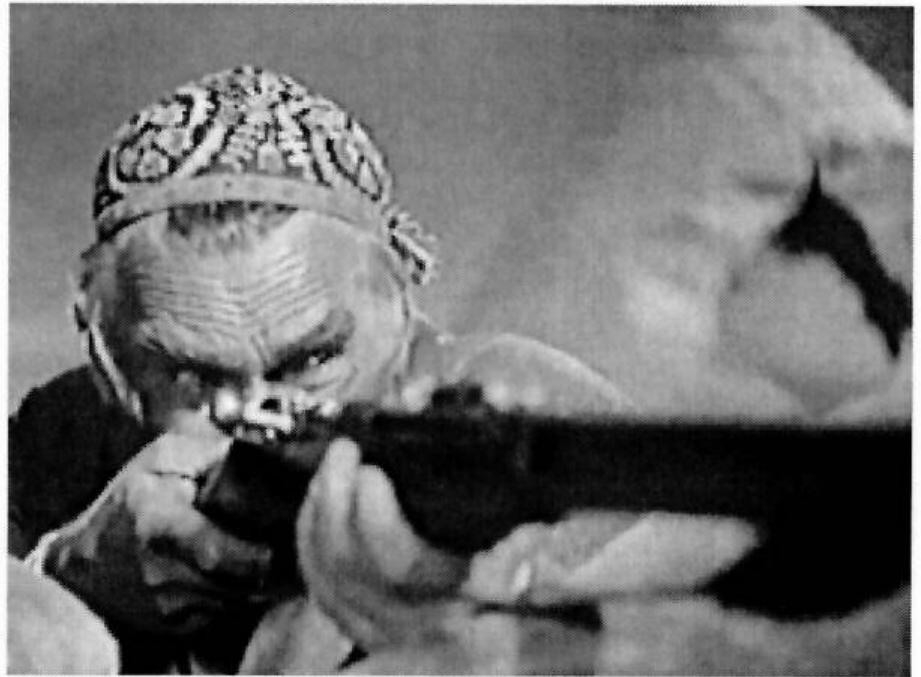 Fig. 5: The geologist learns to shoot a gun like a Bolshevik. Thirteen, USSR. 1936, Mikhail Romm.  role of the »bourgeois specialist: was a stock one in Soviet cinema, but a contem- porary reviewer complained that three different Mosfil’m adventure movies planned for the year 1936 had a geologist character, threatening the transformation of »the adventure genre into a geological expedition.«”” He recommended better coordination of screenwriters with the industry’s central plan. One would think that the geologist might find a way to tap the well or build a tunnel in the rock, but the film values intuitive knowledge over intellectualism. Instead, it is he who must learn military discipline and how to shoot a gun. One of the last men alive, the geologist comes out of the ruin to take up a gun, but he needs a lesson from one of the soldiers. Their extended dialogue about the mechanics of the gun sight gives the spectator a thorough practical lesson as well as an ethical one, in the wake of their need to shoot one of their own. 