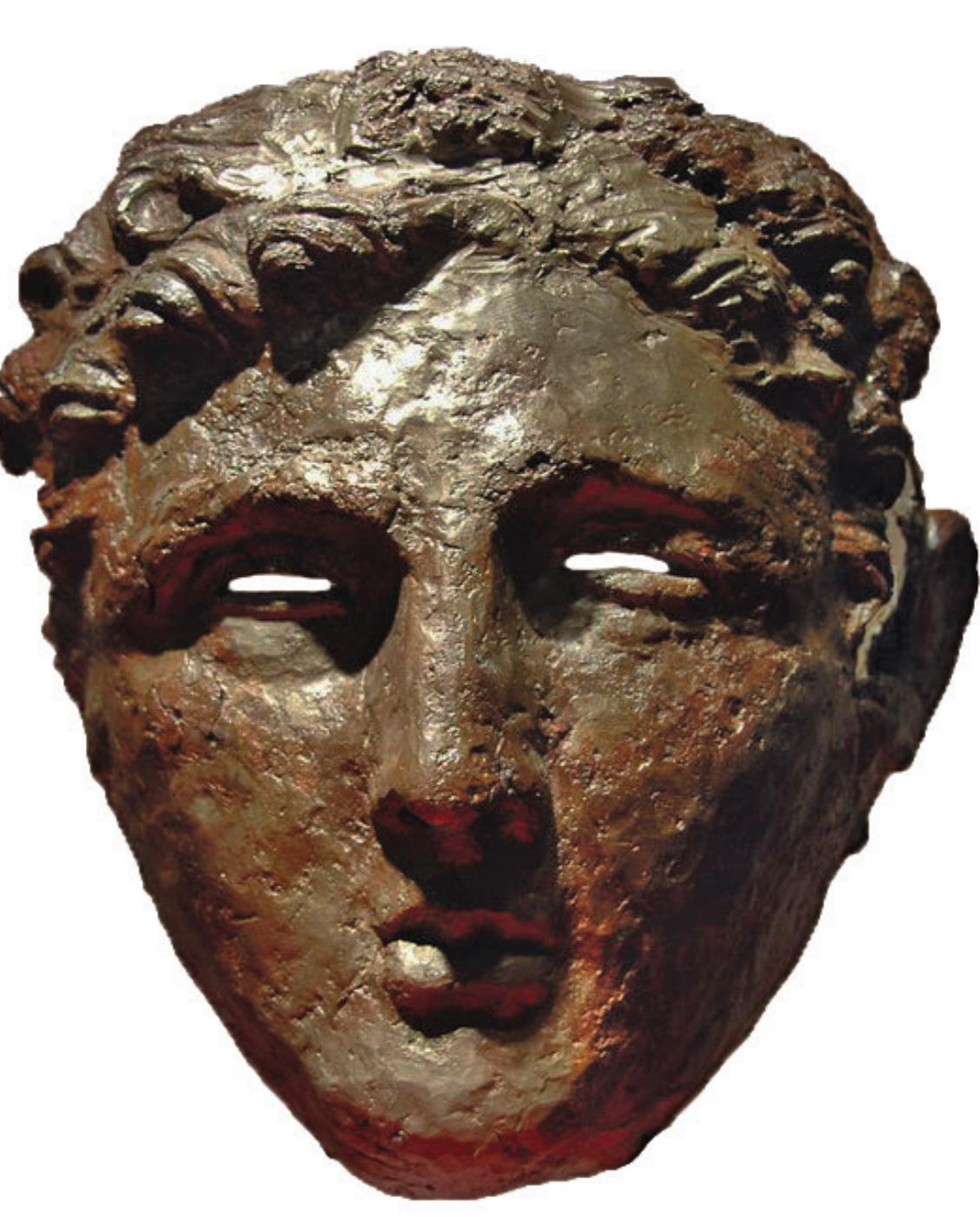 fragment of silver sheet was preserved, c. 2 cm in width, indicating that the mask was originally partially or entirely covered in silver.'"' 