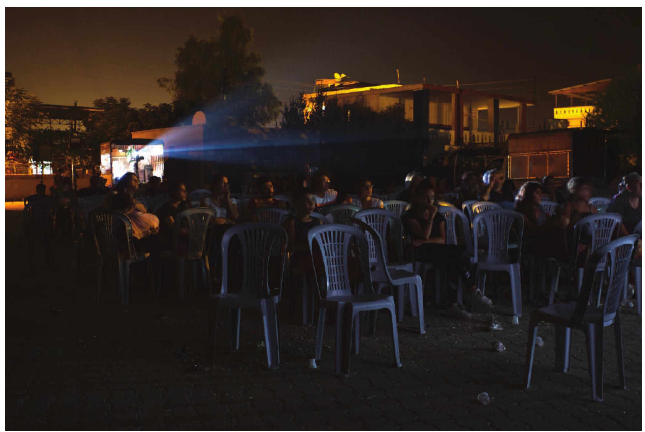 Figure 6. Re-enactment of a travelling cinema exhibition in a school garden — Cinema Nostalgia (Ali Efendioglu Village - Tarsus Plateau, Summer 2019). 