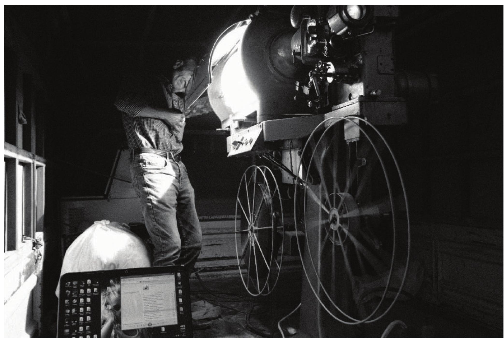 Figure 7. A travelling cinema projectionist controls the light intensity of a 35mm film projector, which is mounted on a truck bed, during the re-enactment of summer time open-air cinema (Bogriiegri Village — the Taurus Mountains, Summer 2019)  diverse ranging from makeshift cinemas on a school’s wall to an 800-person permanent hall, or to 