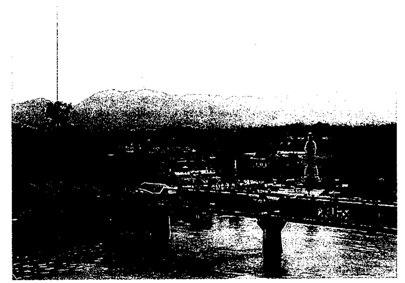 Figure 5.2 The bridge on the River Kwai, and the Buddhist temple constructed in 9011 (source: The late Kim McKenzie by courtesy of Sophie Jensen).  To find the railway depicted as the tragedy that its victims remember, the visitor must look to lesser-known sites in Kanchanaburi town. These have been developed not by public agencies but by individuals, whose varying motives illustrate the multiplicity of meanings that have come to be invested in the railway’s history. This first of these is a small museum in the house of Nai Boonpong Sirivejabhandu in the old sector of the town. A canteen con- tractor to the Japanese during the war years, Boonpong had access to the POW camps as far north as Tha Khanun. Working secretly with a clandes- tine civilian resistance organisation in Bangkok, the V organisation, he used 