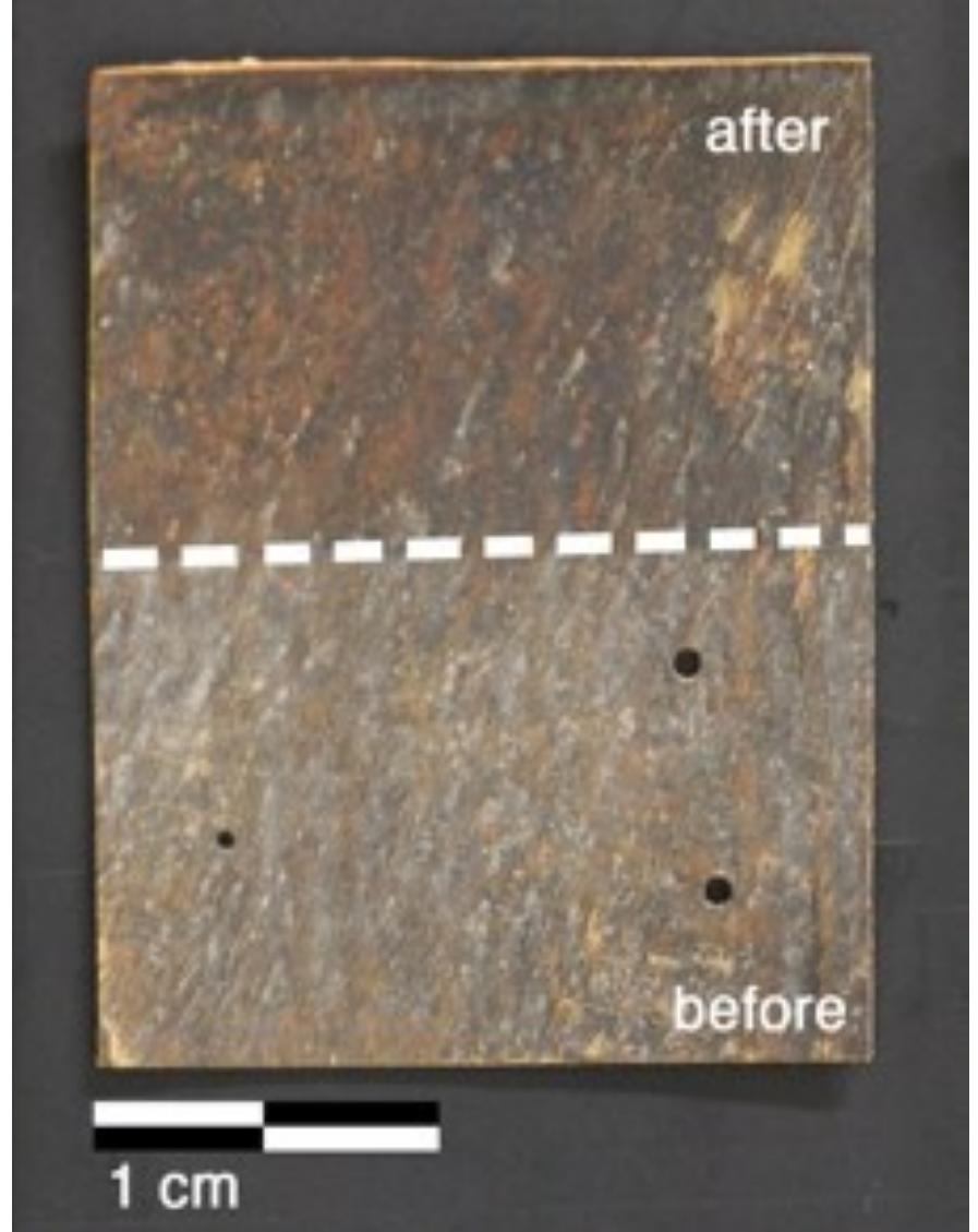 Figure 6 H1 sample (Luther Bible cover,  1749 AD) before (bottom) and after (top) treatment with  the pHEMA/PVP HS58 gel (loaded with |]  EAPC) and a mixed calcium hydroxide — calcium lactate  nanoparticles dispersion in 2-propanol. The area on the bottom shows the dull grayish surface patina of dirt, salts and pollutants. The area on the top shows the removal of the patina to reveal the  underlying heterogeneous leather surface  important to notice that the surface patina must be removed prior to application of the nanoparticles dispersion to favor the penetration of particles and avoid the formation of white veils.  The ATR-FTIR spectrum of the sample before treatment (Figure 8) clearly shows the absorption bands of gypsum at 3525, 3398 cm” (vOH), 1619 cm”! (8OH), 1111 cm’! (asymmetric stretching vibrations of SO,”) and 669 cm” (symmetric bending of SO4”) [31,32]. These absorptions are no longer observable in the spectrum of the sample after treatment with the gel, while the bands of collagen and tannins can be clearly observed, which confirmed the effective removal of the surface patina. Also in this case, no bands ascribable to SDS (1084 em”, vs8O2; 1227 cm”! Vas9O2; 1471 cm’, CH) or to the H58 gel are observable in the spectrum. 