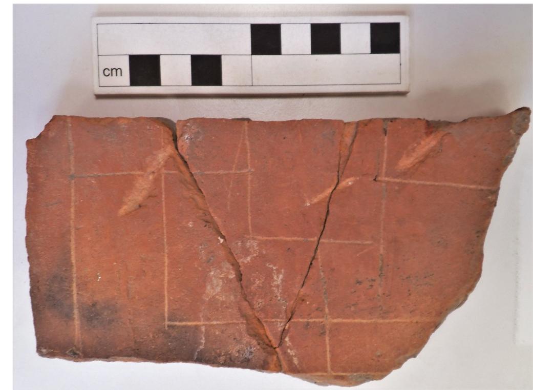 Fig 9 Tile fragment with incised merels-type board design from Cirencester. (Photo: Peter Warry) 