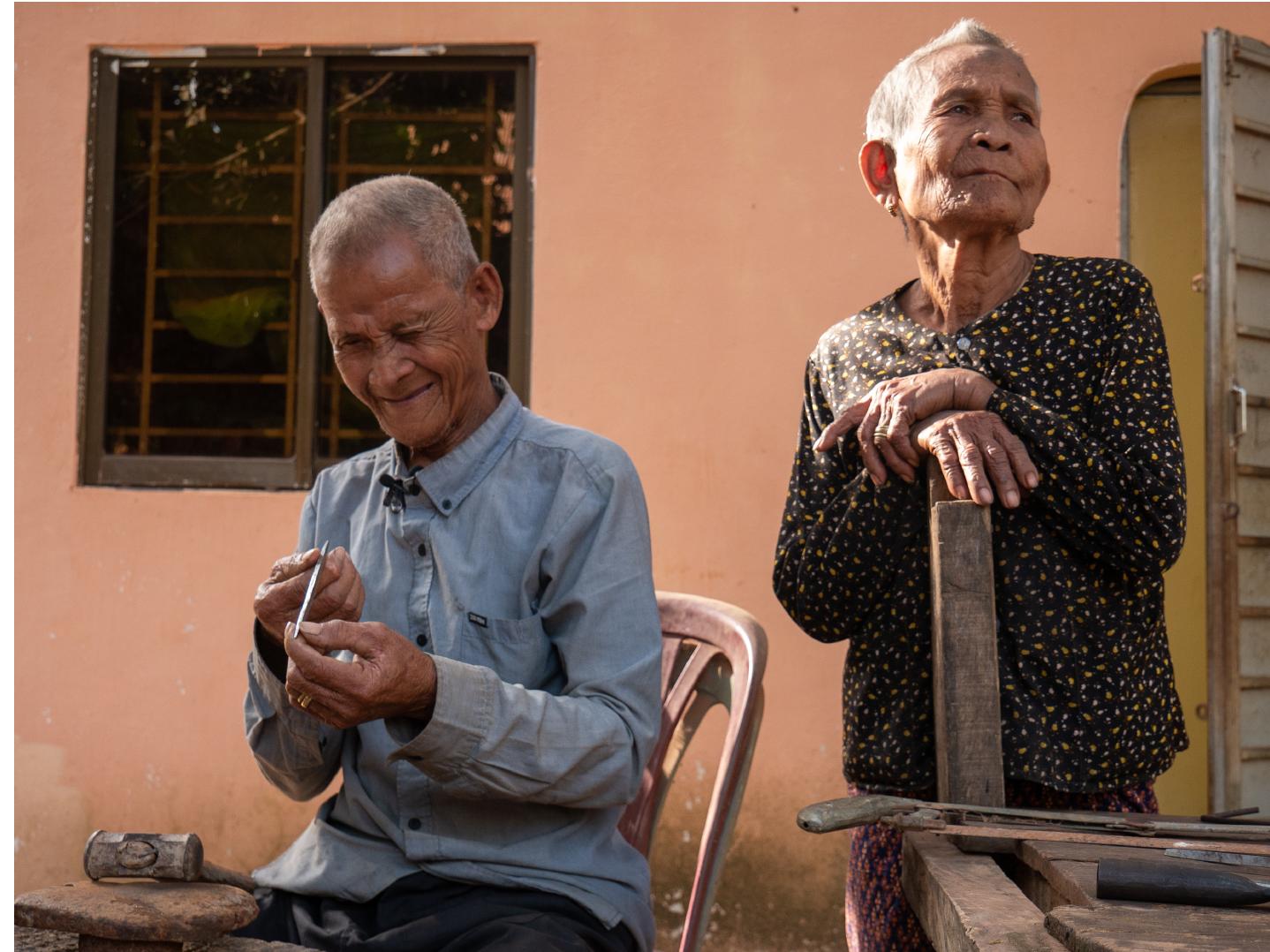 Figure 1: BIN Song making angkuoch daek (iron Jew’s harp) (with his wife, standing). Photo: Catherine Grant, 8 January 2020. 