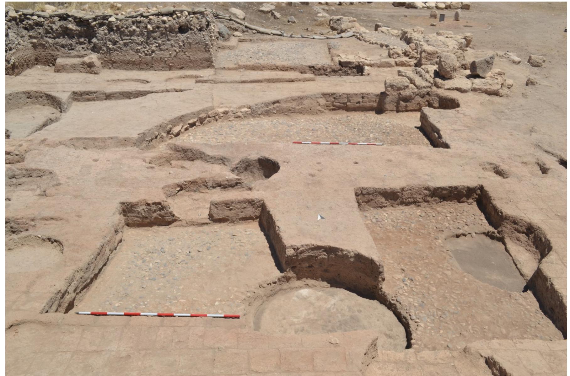Fig. 7.3. Section of the IA I storage complex, the pebbled preparation for the beaten earthen floor in foreground, view from the south. 