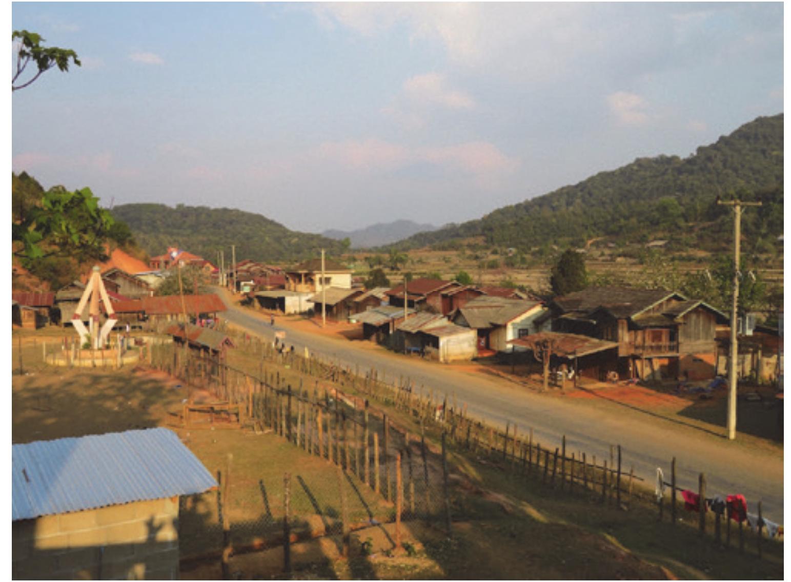 Photo 1: Main road of Ban Saleuy (copy of the Sam Neua monument on the left) 