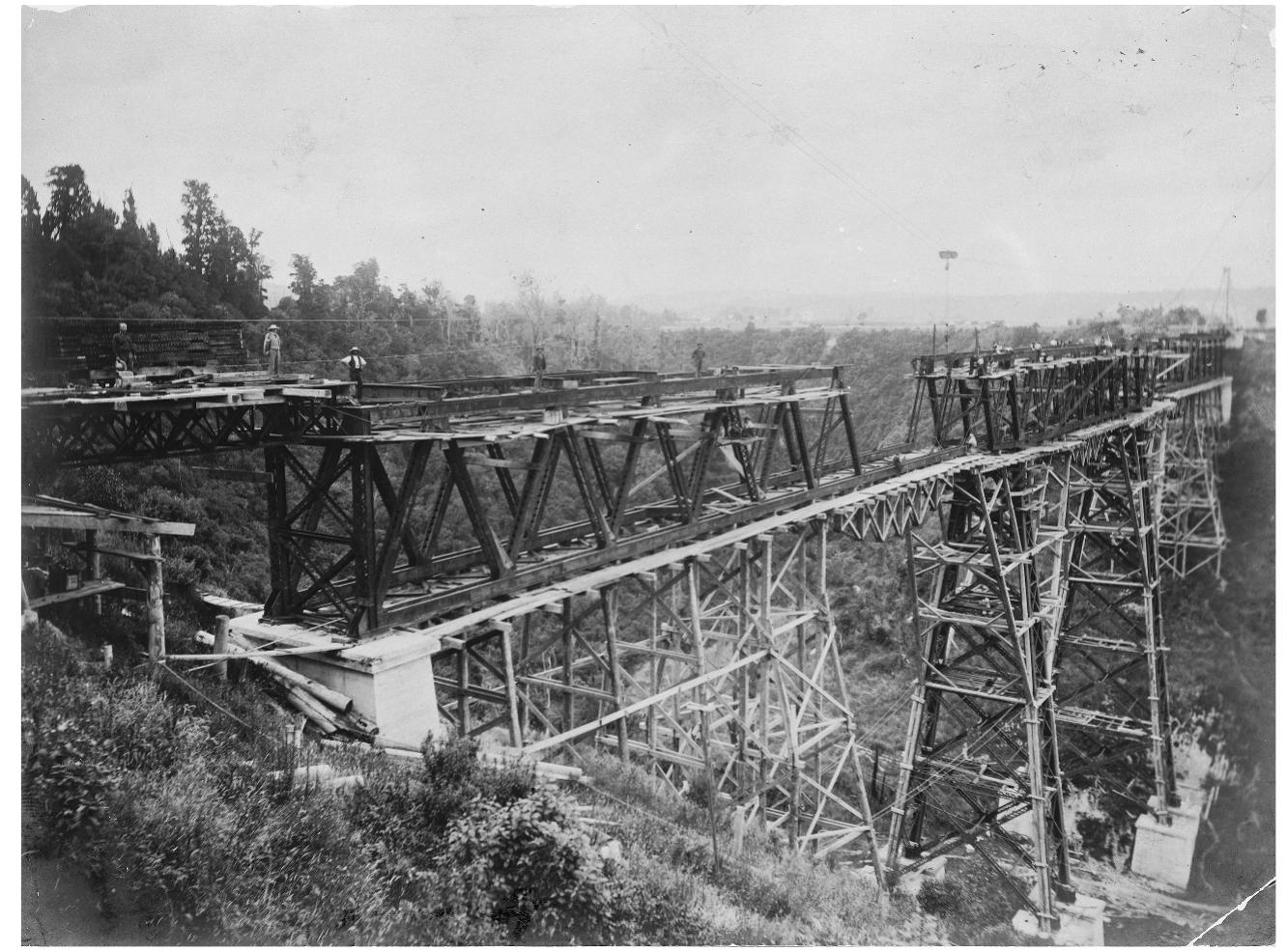 Figure 5. Makohine viaduct under construction. Ref: PAColl-4239-02. Alexander Turnbull Library, Wellington, New Zealand.  The men who are seen in one of our pictures engaged on the Makohine viaduct are ordinary workingmen, but they are not working in an ordinary way. They are their own masters, with no contractor to ‘sweat’ them and without a contractor’s foreman 