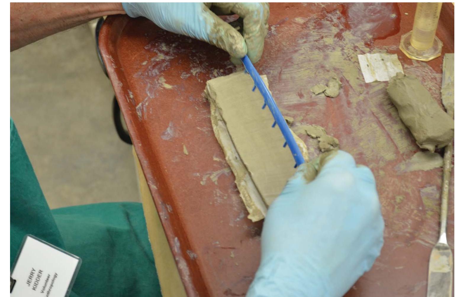 Marking scoring distances on sample clay test bar (with