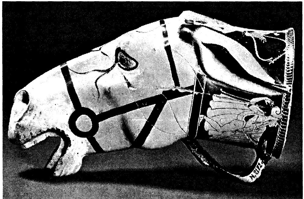 What, if anything, was the Greek response to the mass of wealth and exotica acquired as booty? About the time of the Persian Wars, we see an introduction of new vessel types in the Attic ceramic repertoire, whose origin is best explained as ceramic imitations or adaptations of Achaemenid luxury toreutic vessels. The most famous example is a series of animal-head drinking cups, similar in many respects to the Persian model, but the Greeks added kantharos handles to the Persian handle-less vessel (Figure 4). Moreover, as Hoffmann pointed out, while Attic potters sometimes retained the Persian bestiary (lions, griffins, rams), more frequently they substituted less noble animals, like the dog or donkey.'°  Figure 4: Donkey-head cup, Attic imitation of a Persian animal-head vessel. Attic red-figured mould-made cup, Brygos Painter, ca 480. Musée Jér6me Carcopino, Aleria 2172, Jehasse 1902. Photograph after museum postcard. 