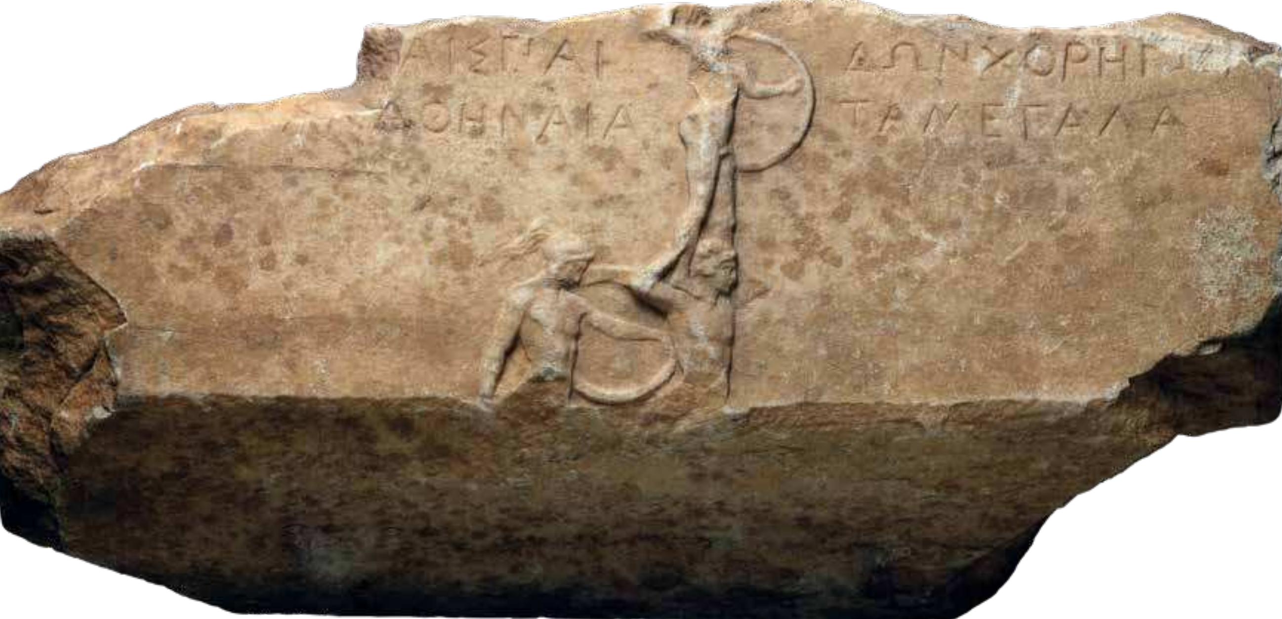 Fig. |. Marble base of a choragic votive NAM [ 3854. From Athens. It commemorates victory in pyrriche in the paides category at the Great Panathenaea depicting the celebration of the  victors. Ca. 375 BC. 