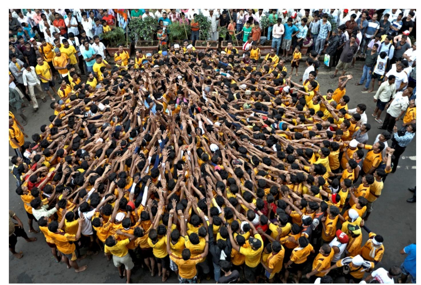 Image 3: The popular Govinda festival involves the creation of a human pyramid to reach a pot with milk and money suspended over the street. The festival celebrates the birth of lord Krishna and is one of the many festivals that temporarily transform the street scale of the city. (photo credit Rajesh Vohra) 