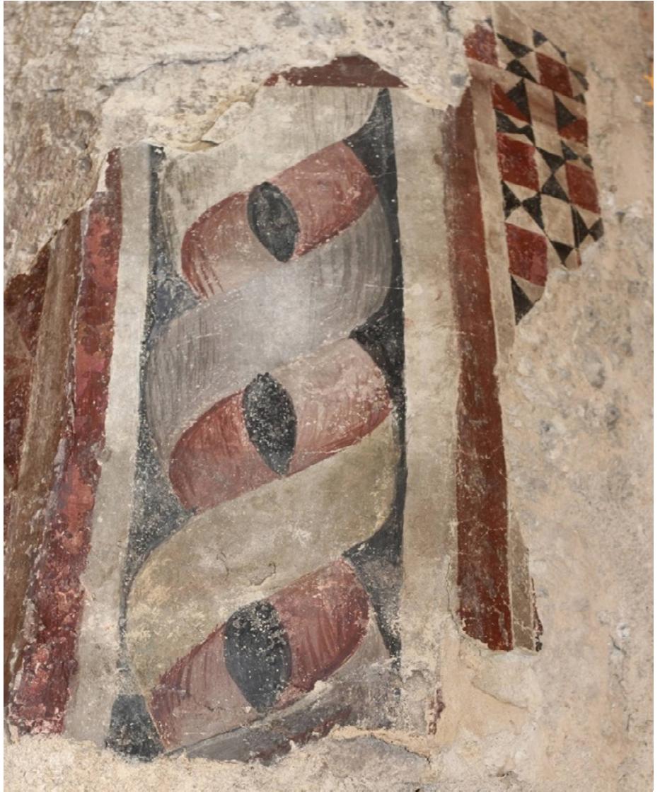 Figure 6. KarlStejn, relic of painted decoration on the triumphal arch of the chapel of St. Nicholas. Between 1350 and 1360. Photo by FrantiSek Zaruba, the author’s own work.  of the decoration, in the form of painted fields. Slightly better-preserved paintings can be found in window scuncheons in a chamber on the second floor of the palace, adjacent to the suite of Emperor Charles IV mentioned above. In the eastern recess there is a coat of arms with the inscription ‘S.P.Q.R.’ surrounded by red floral ornamentation (Figure 7). In the window recess to the west are the coats of arms of Moravia and Luxembourg (the present appearance of this room results from a mid-15th century reconstruction and changes made in the 19th century).  