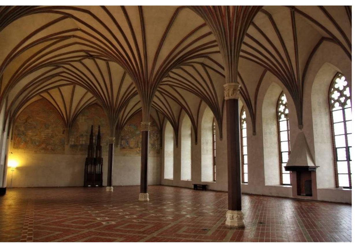 The introduction of a monumental sacral painting with intensive contrasting colors into the secular space reflects the sacral character of the whole complex, which was after all a monastic castle, a castle of Mary, and this emphasized her patronage over t  Knights. From this religious  specific setting of these exped argest hall of Malbork Castle Teutonic Knights in their cru  itions was also associated with the Grand Refec  sades were received at feasts (J6Zwiak and Tru  he Teutonic  perspective, the Order had a mission of converting pagans, which at that time took the form of armed raids on the lands of the Lithuanians, and the  ory. In this  , western European guests of the Order there to support the  pinda 2019,  pp. 300-1). They admired the magnificent fresco depicting the patroness of the order and their mission of pursuing the ideal of the Christian knight. On the northern wall of the refectory, they could view another painting, now preserved only fragmentarily, a multi-level composition depicting a procession of knights with banners (Herrmann 2019, pp. 292-93). This element of visual propaganda displayed the purpose of the mission, which included the guests of the Order setting out from Malbork on an armed expedition against the pagan Lithuanians in a military procession similar to the knights in the fresco, all under the patronage of Mary.  Figure 13. Malbork, Marienburg castle, Grand Refectory. Photo by Tomasz Ratajczak, the author’: own work. 