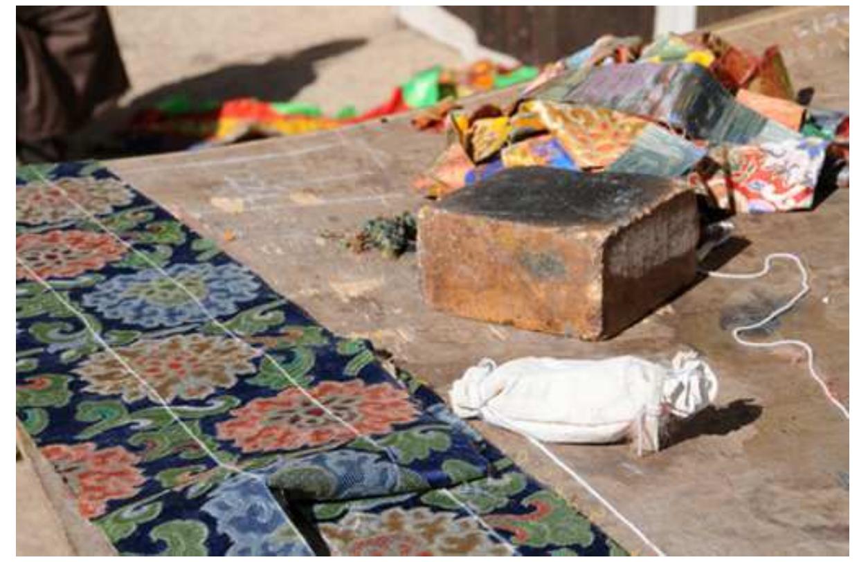 Offering textiles tailored to robes for deities and ritual