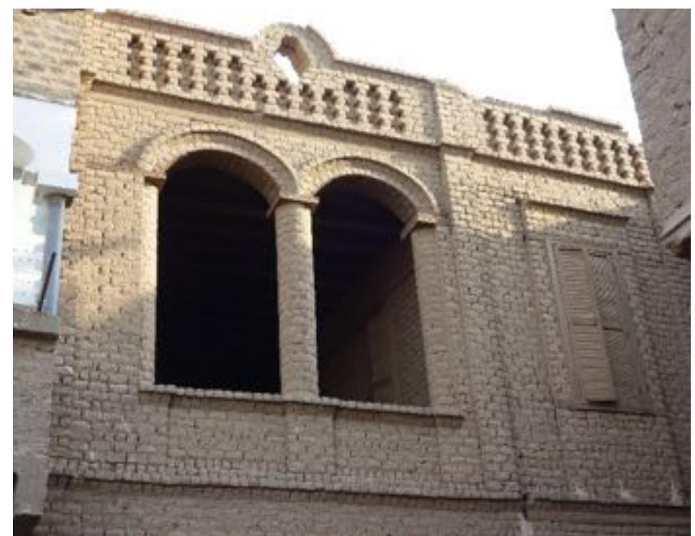 Protruded brick design on roof parapet and arches in