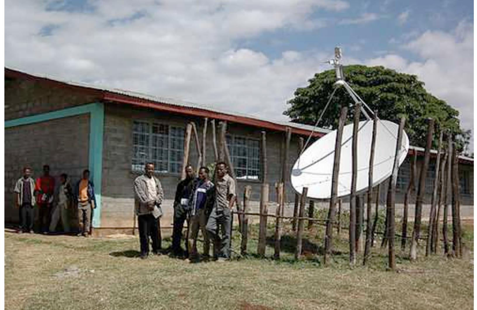 Figure 2: “Plasma” TV satellite installation in a school Source: Heavens, 2005. Copyright Andrew Heavens of www.meskelsquare.com. Reproduced by permission.  [he point here is, at any circumstance, the “plasma” cannot be a substitute for a eacher in the classroom as it is occurring now in Ethiopia. Nothing can substitute the ive interaction between the teacher and the students as well as among the students as earning is also social in character. Much literature supports the theory that mteractions among students and between the students and teachers enhance the students’ opportunity for learning to think critically in the traditional classrooms Brookfield, 1987). Otherwise, the students’ role will be restricted only to listening which may, at most, result in rote and passive learning. This legitimates the practice of what Freire (1993) described as the “banking” concept of education which denies dialogical” relation among the learners and between the learners and the teacher. If, it least, it was an interactive TV in which students can also get the access to watch while other students interact in the classroom in the same topic, and had additional ‘ime to discuss with their teachers and their fellow students, it would be preferable. There are findings which support the idea that using interactive TV in teaching is as »ffective as face to face instruction with regard to acquisition of critical thinking skills which includes reasoning, solving problems, creating and evaluating knowledge  ‘Huff, 2000).  