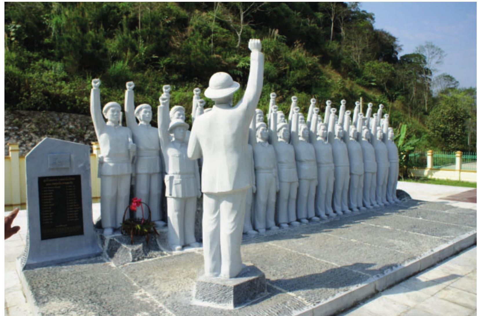 Figure 1. Monument to the 25 Heroes, signifying the importance of the Ksingmul area to the early days of the Revolution, and the transformation of Ksingmul from Puak to Lao May.  yellow. Village elders describe this period of their history as kuyh tuup Plaa ‘living in banana leaf huts,’ endorsing the notion of Yellow Leaves. According to the narrative, hey abandoned agriculture for hunting and gathering, led mostly by the availability of ubers, only cooking at night to avoid giving their location away. It is interesting to note hat the term for the ‘house’ of the 1907 lian lifestyle is not a single lexeme, and includes he Tai borrowing tuup ‘thatched hut’. The “normal” word for house in Ksingmul is jiay, with cognates in several other languages in the area that mean house (in a village). This inguistic evidence—the lack of a specific word for temporary forest huts as opposed Oo more permanent houses—supports the idea that the to0n lian lifestyle was something hat they adopted from a more sedentary livelihood. This is also when the old puak erm was re-interpreted to mean ‘termite’, as they now lived like puak doy (Tai: ‘forest ermites’), hidden from view and consuming the trees from the inside, little by little.  