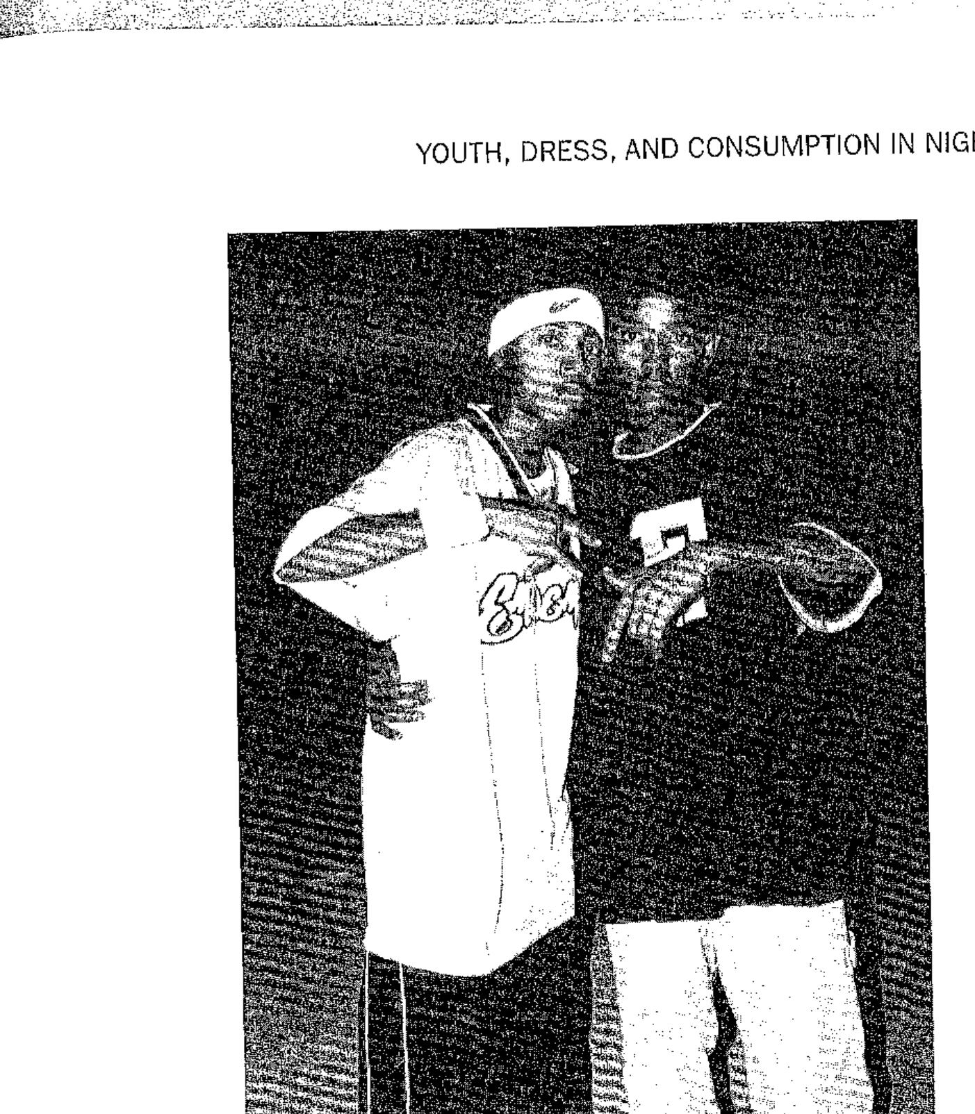 2 young men dressed as rappers posing at a dance party.