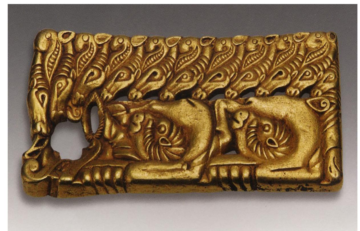 Figure 18. Gold buckle, Zhushan county, Hubei province. Western Han. Source: Wenwu 2010.9, inside cover top  in Ordos. Even more faithful to steppe visuality are the contorted ram bodies arranged in a row. The animals are not fully outlined but rather abbreviated, schematically rendered to the degree of extreme abstrac- tion. One can decipher their identities through their heads and textured horns. One starts to consider the possibility that steppe zoomorphism penetrated much further into the heartland of the Han empire than has been hitherto assumed. To see references to animal-style art all the way in the Chu domain is astounding considering the vast distance from the northern frontier zone. During the Warring States, marked by Chi- na’s first intensive encounters with the northern nomads, one observes a much more contained diffusion of steppe visuality and techniques— for the most part, animal-style portable luxuries were circulated in the Ordos Loop, Gansu, and Xinjiang—the regions normally associated with these types of cross-cultural encounters. This trajectory seems to have changed and its scope widened in the Western Han, especially as the Xiongnu became a serious geopolitical factor at the northern border, and trade routes expanded significantly.  The ram configuration from Xuzhou reappears on a buckle unearthed  
