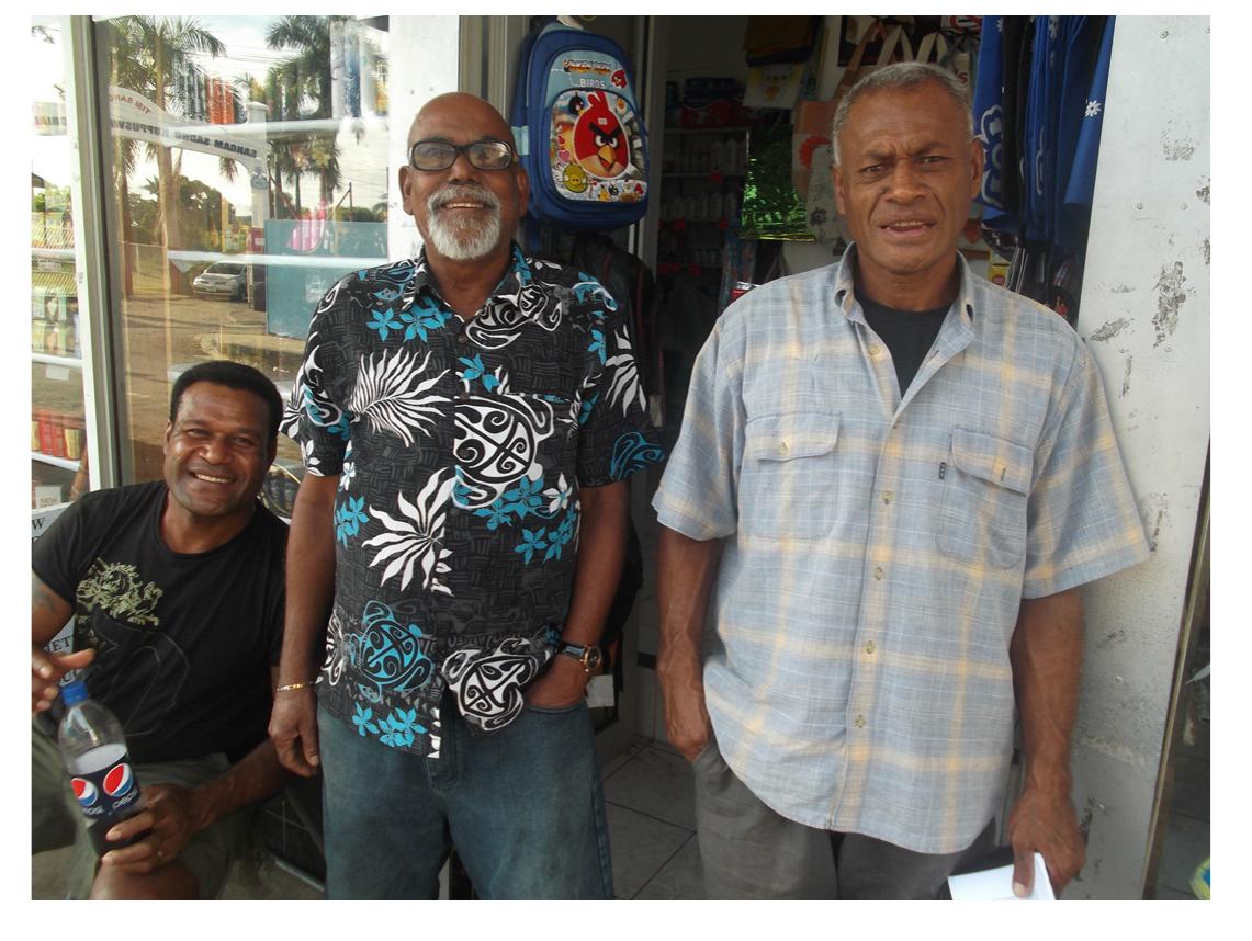 Figure 2 — Henry Dyer (right) with Nadi fans in Nadi town. Retired ambulance driver Vijay Prakash is at center. 