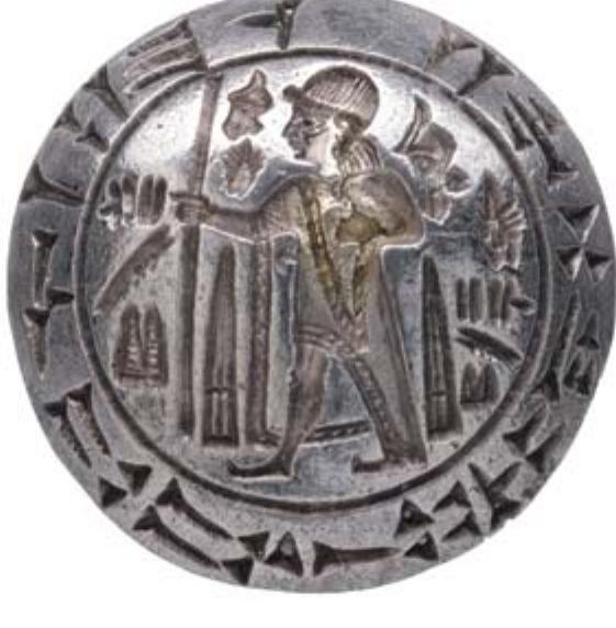 FIGURE 5: Silver boss of the so-called Tarkondemos seal, probably the top of a sword hilt, inscribed in cuneiform and in Luwian hieroglyphs round a figure of an Anatolian king (© The Trustees of the British Museum). 